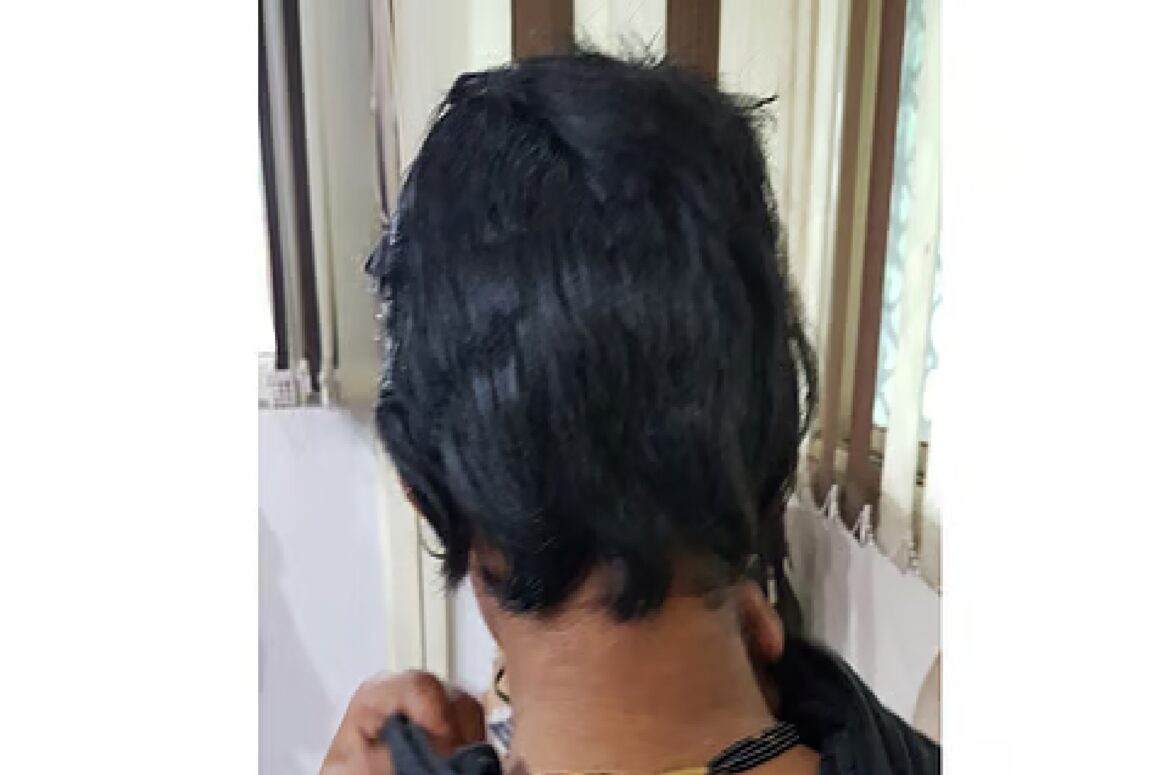 Husband cuts wife's hair